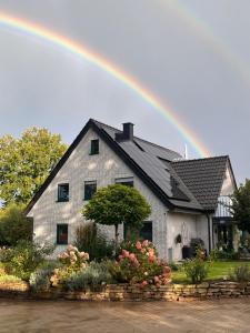 a rainbow over a house with at Landhaus Upn Wall mit Ponyreiten und Kutschfahrten in Mettingen
