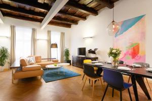 a living room with a table and chairs and a couch at U Kapra Apartments in Prague