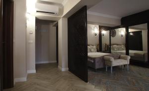 a bedroom with a bed and a large mirror at Apartament AMBER CHRISTMAS MARKET in Brăila