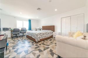 a bedroom with a bed and a table and a couch at Luxe Stay Room with Private Bathroom 55 in Los Angeles
