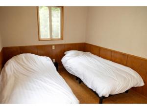 Ένα ή περισσότερα κρεβάτια σε δωμάτιο στο Beach Front Litore Iritahama - Vacation STAY 33142v