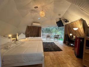 a bedroom with a bed in a tent at PhuKasa Valley Maesot -Wellness Resort in Ban Mae Kasa