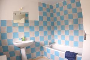 a bathroom with a sink and a toilet and a tub at Chateau de Flottemanville in Flottemanville