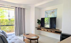 a living room with a large flat screen tv at Surf Stay in Singleton