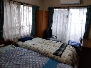 Postel nebo postele na pokoji v ubytování OSO Homestay
