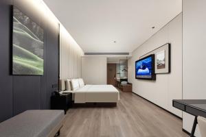 Voodi või voodid majutusasutuse Atour Hotel Fuzhou Mawei Free Trade Zone Oriental City toas