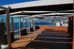 a patio with a view of the water at Hotel Florencia Suites & Apartments in Antofagasta