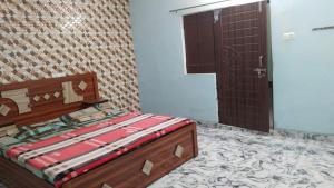 Postel nebo postele na pokoji v ubytování Narsingh Sadan Home Stay