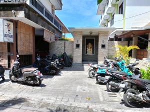 a row of motorcycles parked outside of a building at Ronta Bungalows in Legian