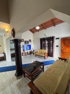a living room with a couch and a table at Thotadagadde Homestay in Mudigere