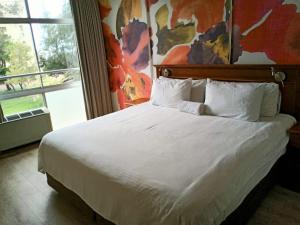 En eller flere senge i et værelse på Oceanic 24 North Beach