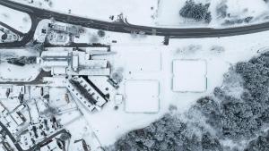 an aerial view of a building in the snow at Hotel Kranjska Gora in Kranjska Gora