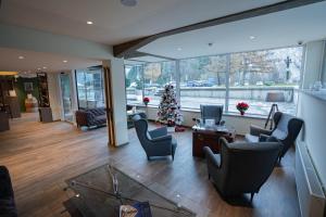 a living room with chairs and a christmas tree at Hotel Kranjska Gora in Kranjska Gora