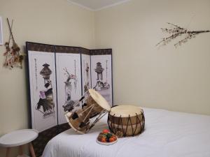 a room with a drum and a bowl of fruit on a bed at UngsungKo Land # Family trip # Soongsil University # Chung-Ang University # Sangdo Station # OTT in Seoul