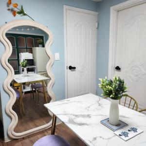 a room with a mirror and a table with flowers on it at UngsungKo Land # Family trip # Soongsil University # Chung-Ang University # Sangdo Station # OTT in Seoul +30 photos