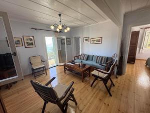 a living room with a couch and chairs at Kioni - Andriana's House in Kiónion