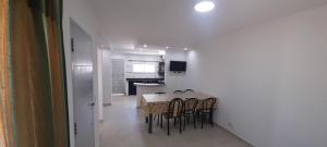 a kitchen and dining room with a table and chairs at los QUISPER in San Bernardo +21 photos