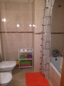 a bathroom with a toilet and a tub and a sink at Apartment Verge de Montserrat in Cambrils