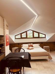 a bedroom with a bed and a table and chairs at La Bellavista Castello in Melfi