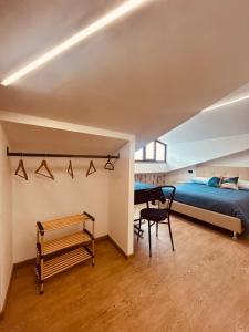 a bedroom with a bed and a desk at La Bellavista Castello in Melfi
