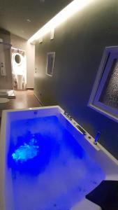 a large pool of blue water in a room at Dimora 900 in San Severo