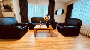 a living room with two leather chairs and a coffee table at The Green Park Taksim in Istanbul