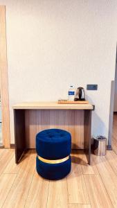 a blue stool sitting in front of a desk at The Green Park Taksim in Istanbul