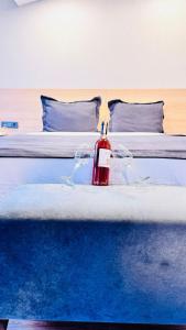 a bedroom with a bed with a red bottle on it at The Green Park Taksim in Istanbul