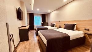 a hotel room with two beds and a television at The Green Park Taksim in Istanbul
