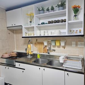 a kitchen with white cabinets and a sink at UngsungKo Land # Family trip # Soongsil University # Chung-Ang University # Sangdo Station # OTT in Seoul