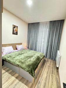 a bedroom with a bed and a window at Eco Cottage BaBi in Bakuriani