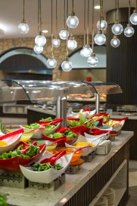 a buffet line with many plates of food at The X Belek in Belek