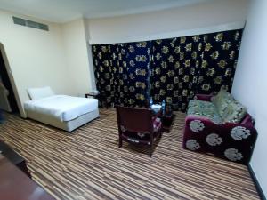 Postel nebo postele na pokoji v ubytování Grand PJ Hotel