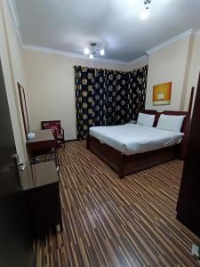 Postel nebo postele na pokoji v ubytování Grand PJ Hotel