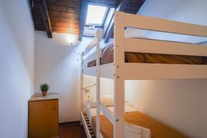 a bedroom with two bunk beds and a lamp at La Corte Antica in Cassina Valsassina
