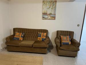 a couch and a chair in a living room at Casa de Férias in Ferro +34 photos