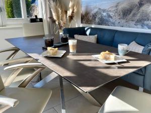 a dining table with two plates of food on it at Ferienhaus Mee(h)rZeit in Zingst
