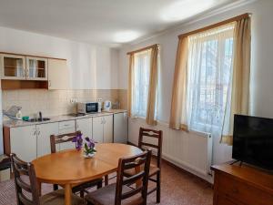 a kitchen and dining room with a table and chairs at Todeva House Hotel and Tavern in Bansko