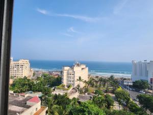 a view of a city with the ocean in the background at Sea Doll 7th floor in Visakhapatnam