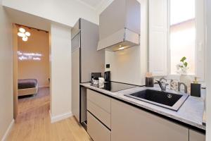 a kitchen with a sink and a counter top at Home Sweet Rome Lucina in Rome