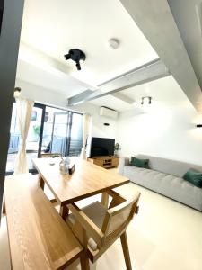 a living room with a wooden table and a couch at City Secret Garden House in Sydney in Sydney