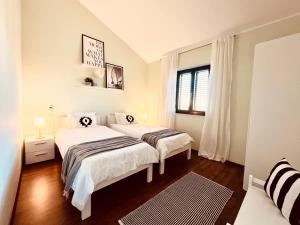 a bedroom with two beds and a window at Ferienhaus Sonnenliebe mit Pool bei Zadar in Radovin +56 photos