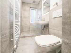 a bathroom with a toilet and a sink at Tolstov Apartments - 2 Room Apartment - 25 min Messe DUS in Duisburg