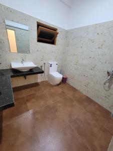 a bathroom with a toilet and a sink at captain mirissa in Mirissa