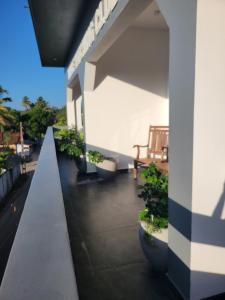 a balcony of a building with benches on it at captain mirissa in Mirissa