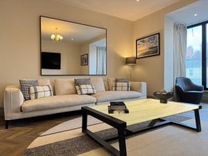 a living room with a couch and a table at Priory Castle Apartment, Tynemouth in Tynemouth