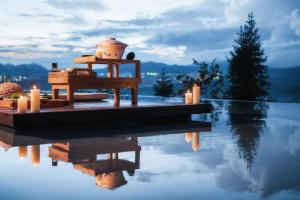 a house on a dock next to a body of water at Tengchong Bodu Hot Spring Resort Hotel in Tengchong