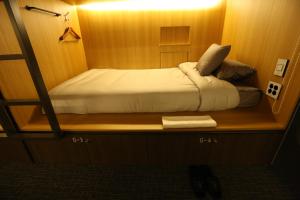 a small room with a bed on a shelf at Philstay Myeongdong Boutique Female in Seoul