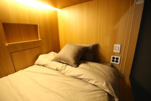 a small bed with a pillow in a room at Philstay Myeongdong Boutique Female in Seoul