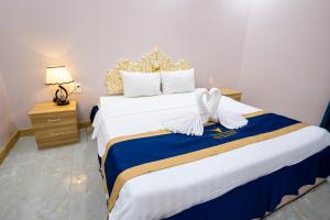 Postel nebo postele na pokoji v ubytování Quoc Vinh Hotel